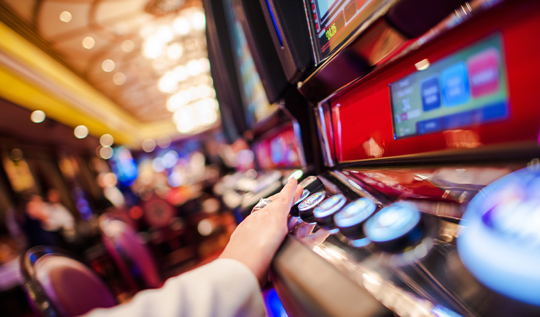 Casino hall filled with people playing slots